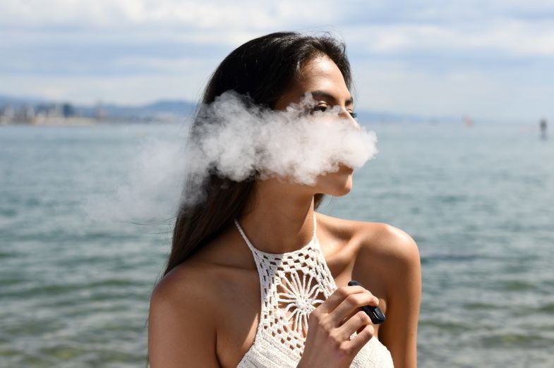 Fille utilisant la première cigarette électronique